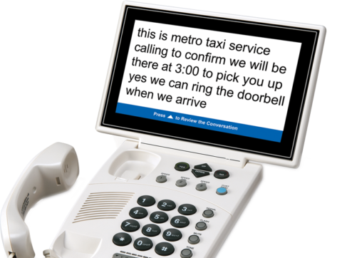 Image of IT CTS phone with large text showing, "this is metro taxi service calling to confirm we will be there at 3:00 to pick you up yes we can ring the doorbell when we arrive."